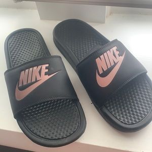 Black Nike slides with rose gold logo